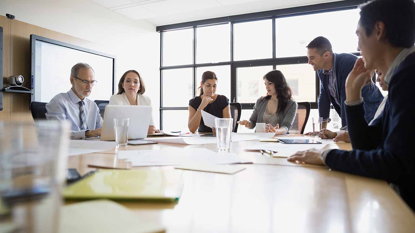 A group of people sitting in a boardroom