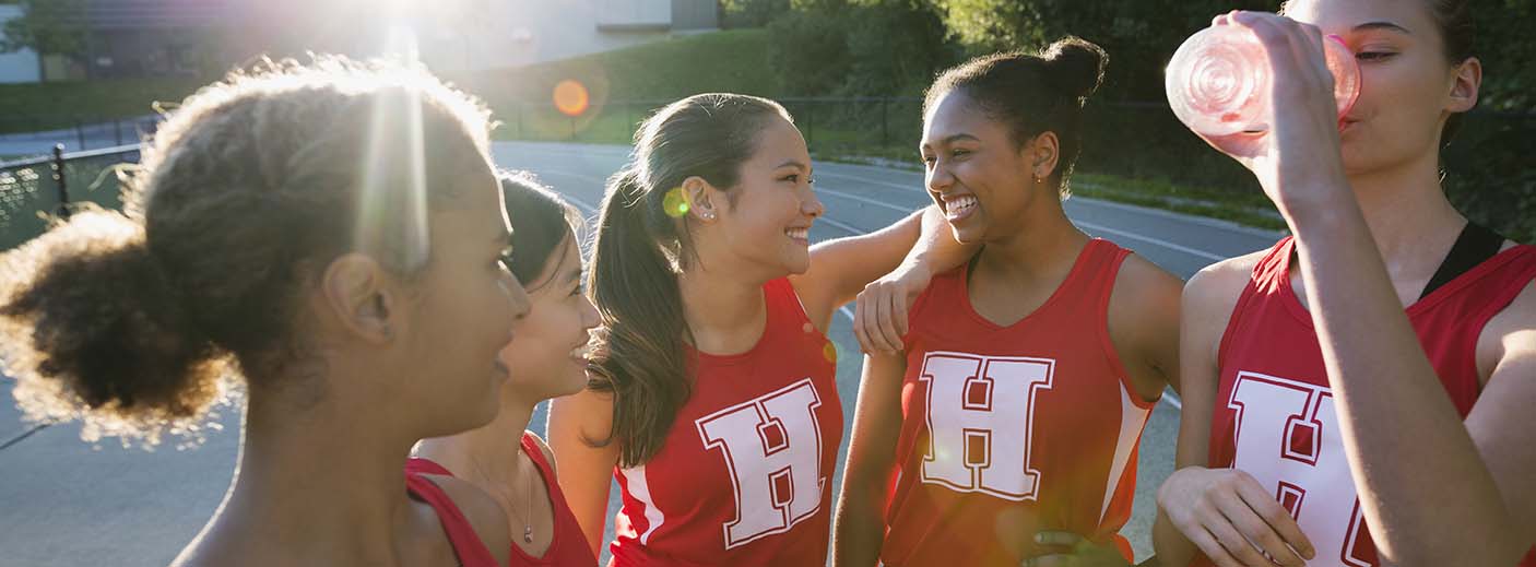 A group of netballs talking and drinking water