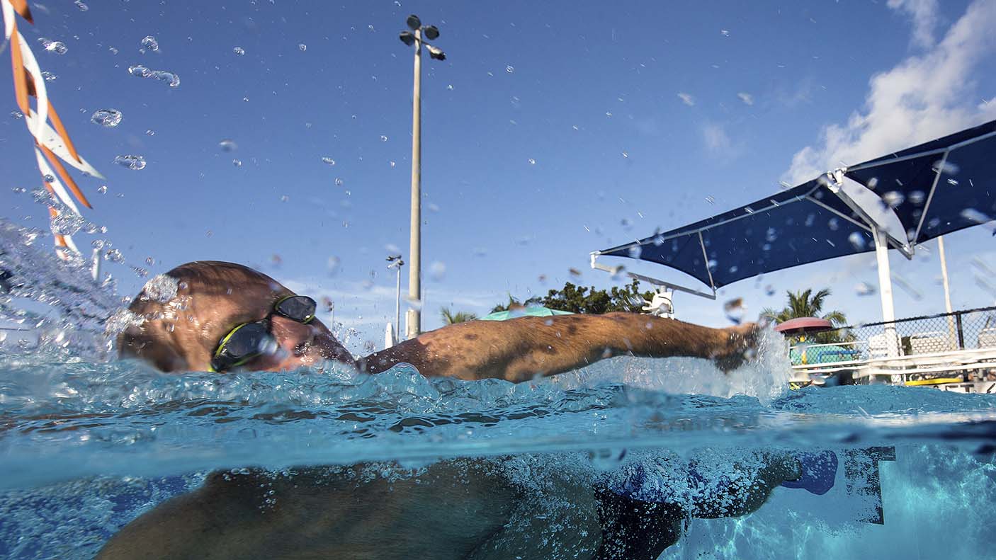 A person swimming at a local swimming pool