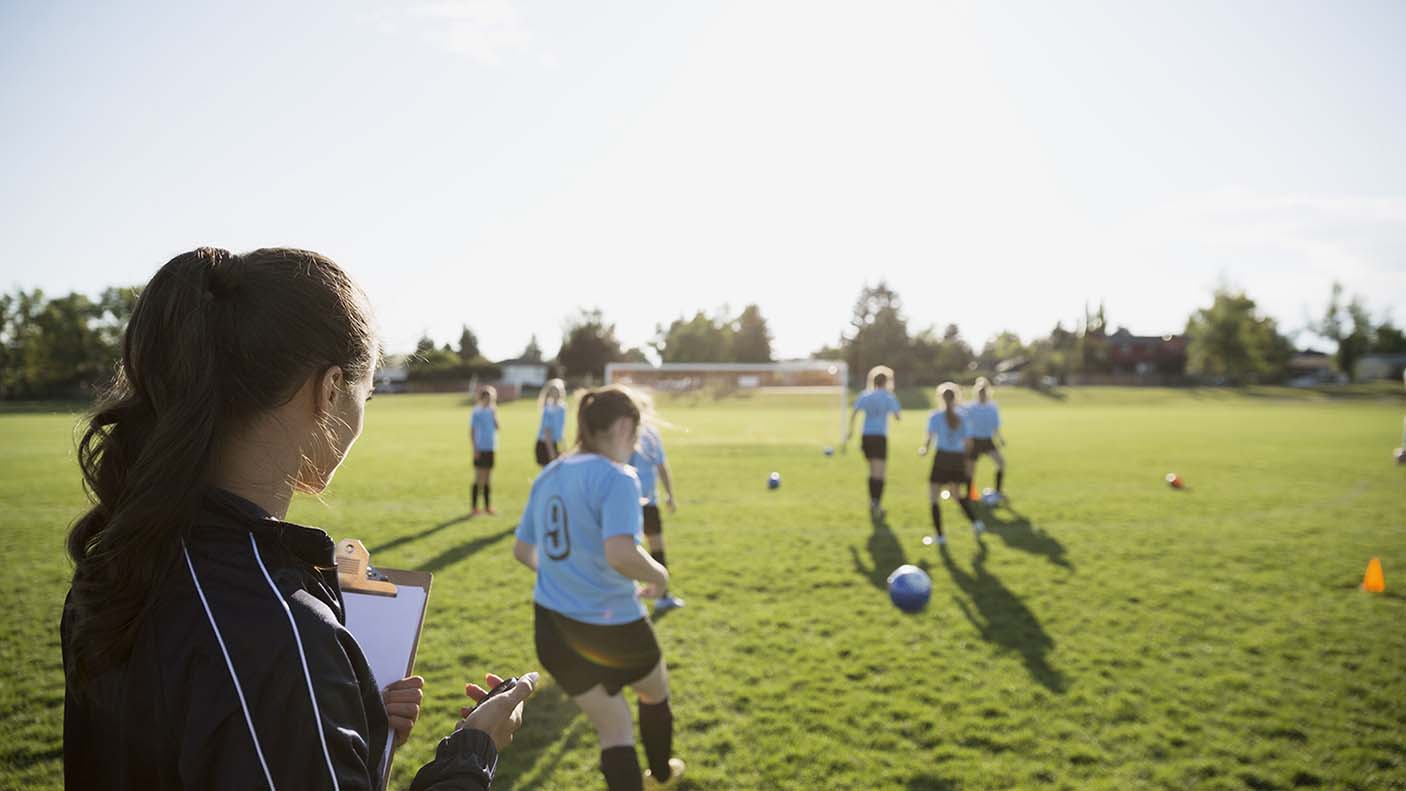 A coach watching her players