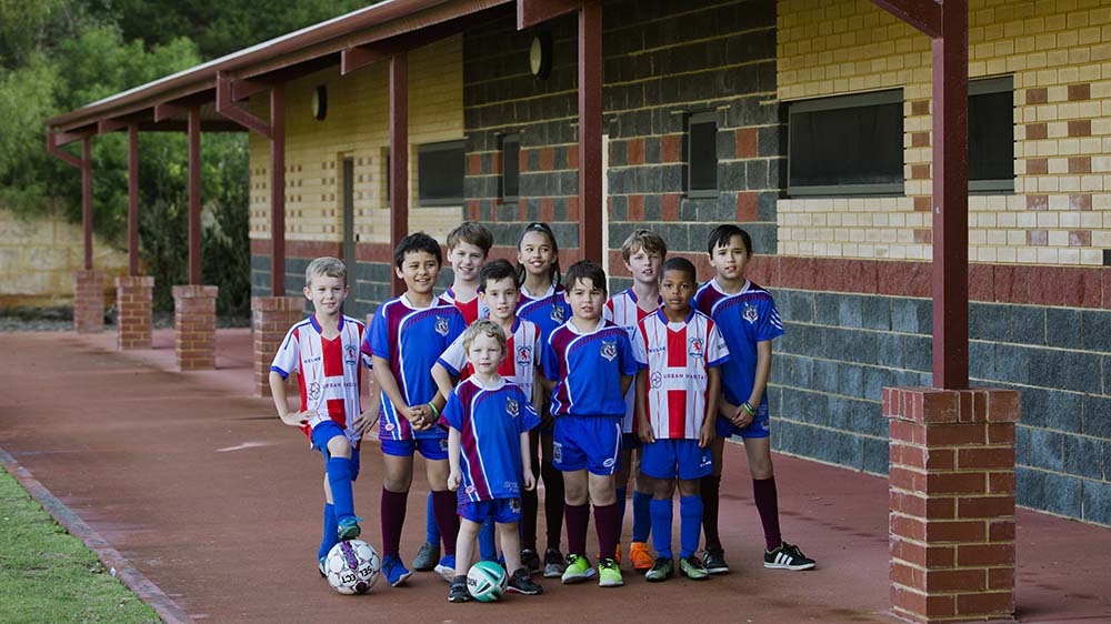 KidSport kids in front of a club house