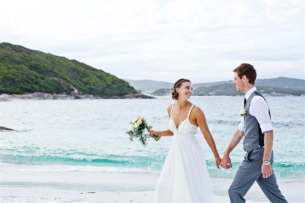 A newly wedded coupl on a private beach